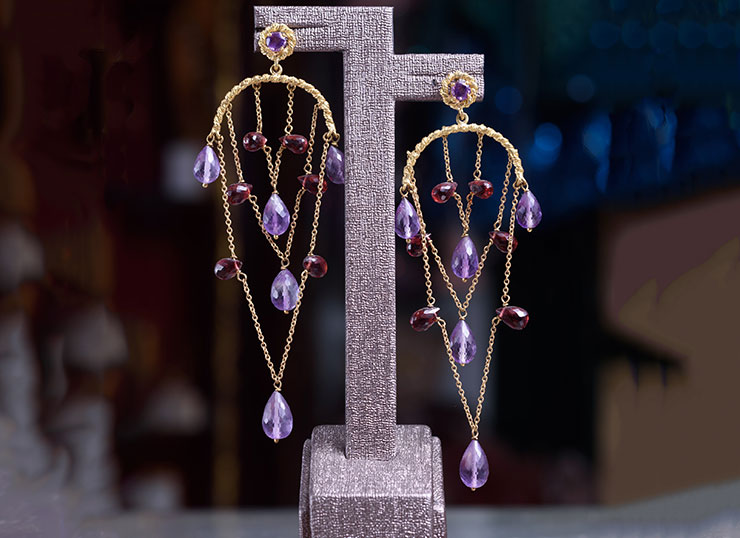 Unique 18ct gold earrings adorned with amethyst and garnet stones