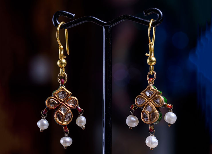 18ct gold earrings adorned with diamonds and pearls, featuring intricate design