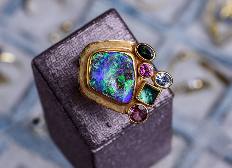 18ct gold ring featuring opal, tourmalines, aquamarine, and emerald stones